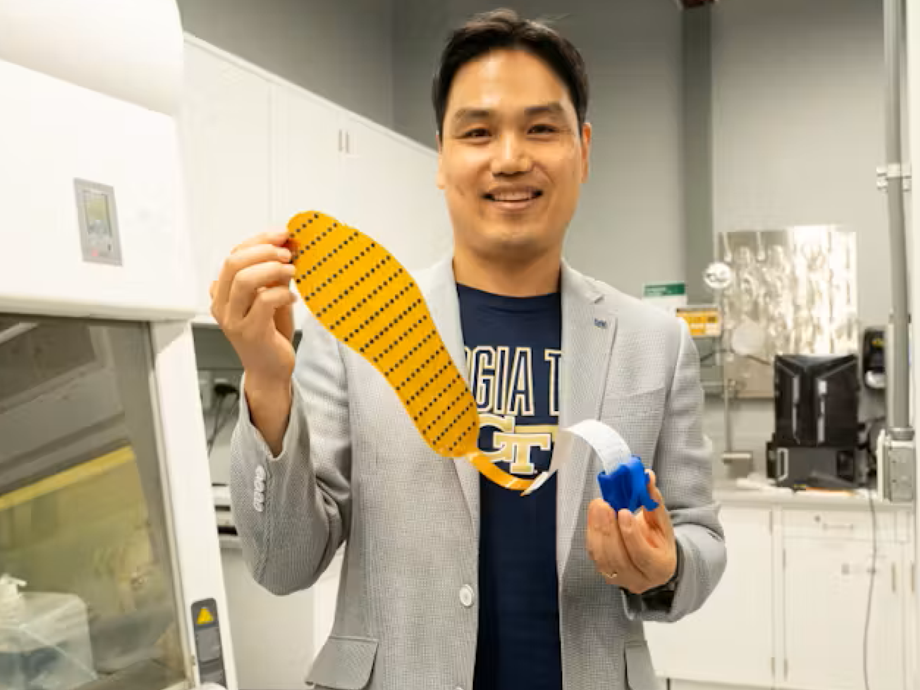 man holding up a shoe insert device