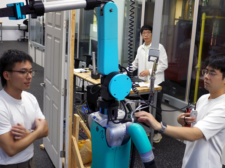 students in a lab working on a robot